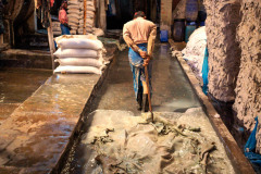 A worker drags several water-soaked hides behind him at a tannery in Hazaribagh, Dhaka.